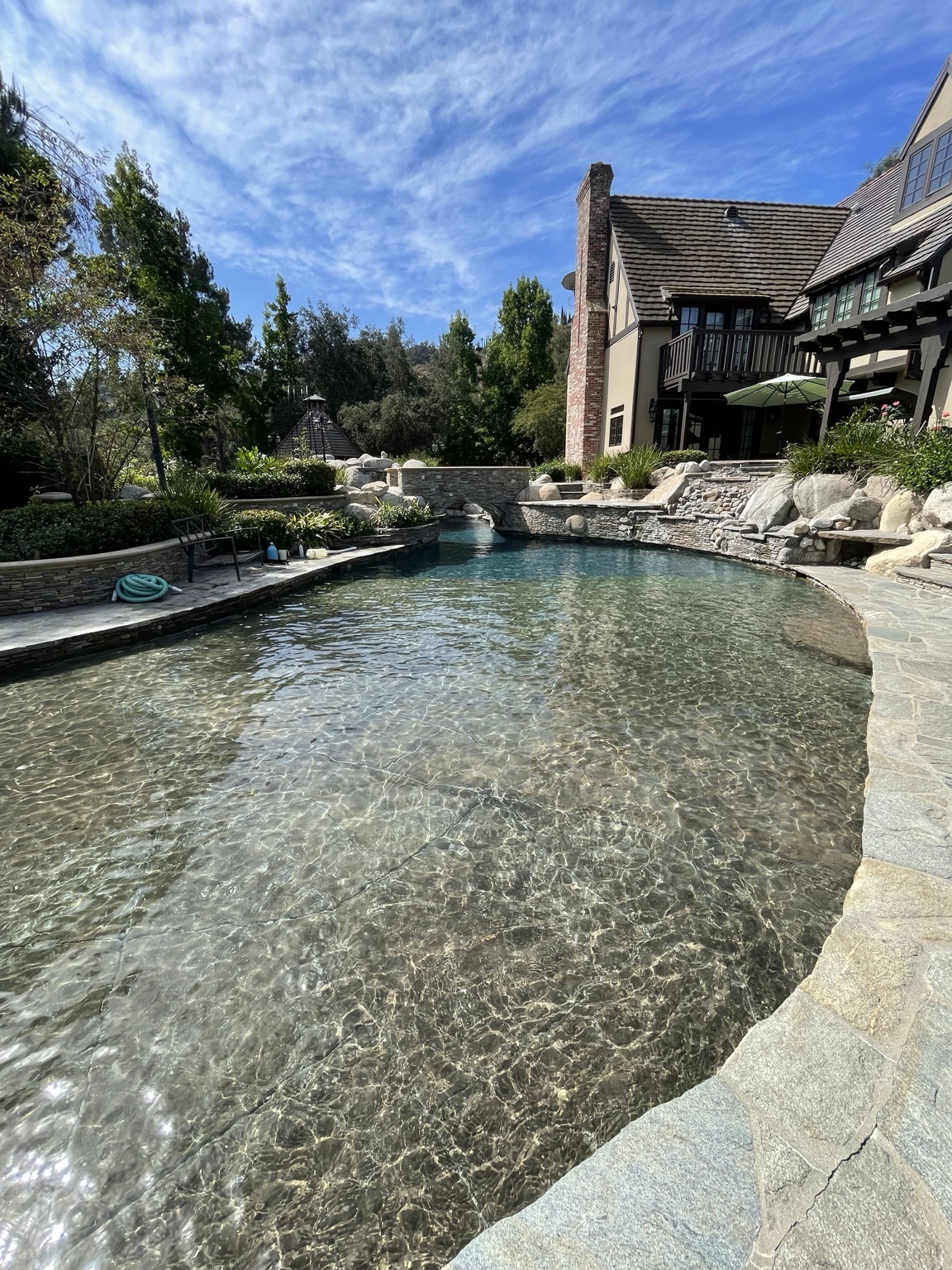 Residential pool and spa with landscaping and blue water